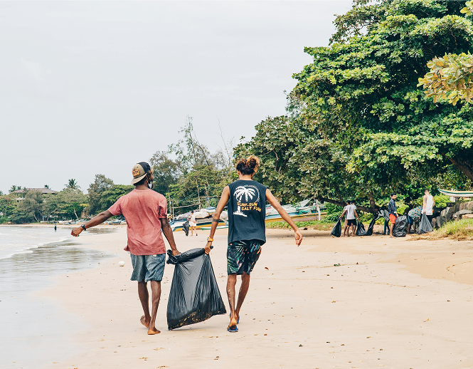 Two people cleaning the beach
