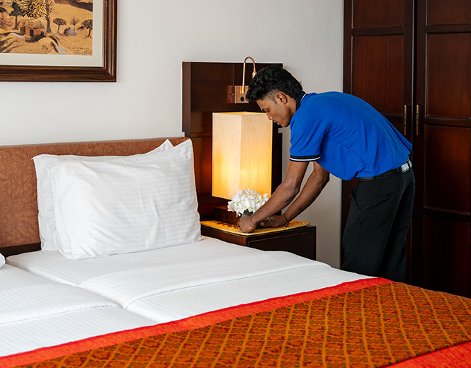 Staff member preparing a room at Fox Jaffna by Fox Resorts Sri Lanka