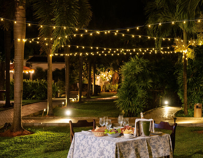 Evening outdoor dining in a landscaped garden setting
