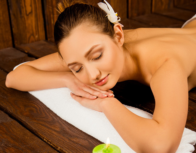 Woman relaxing in spa with candles and flower at Fox Resorts Sri Lanka